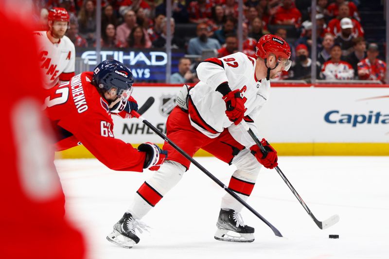 Mar 22, 2024; Washington, District of Columbia, USA; Carolina Hurricanes center Evgeny Kuznetsov (92) skates with the puck past Washington Capitals left wing Ivan Miroshnichenko (63) during the first period at Capital One Arena. Mandatory Credit: Amber Searls-USA TODAY Sports