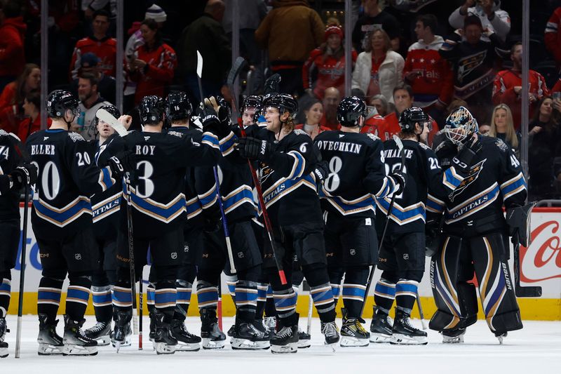 Jan 18, 2025; Washington, District of Columbia, USA; Washington Capitals players celebrate after their game against the Pittsburgh Penguins at Capital One Arena. Mandatory Credit: Geoff Burke-Imagn Images