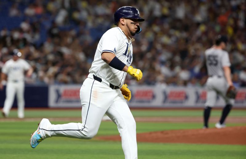 Jul 9, 2024; St. Petersburg, Florida, USA;  Tampa Bay Rays third base Isaac Paredes (17) hits a threenrun home run against the New York Yankees during the first inning at Tropicana Field. Mandatory Credit: Kim Klement Neitzel-USA TODAY Sports