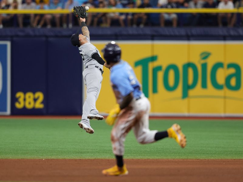 Aug 27, 2023; St. Petersburg, Florida, USA;  New York Yankees second baseman Gleyber Torres (25) leaps for a ball against the Tampa Bay Rays in the sixth inning at Tropicana Field. Mandatory Credit: Nathan Ray Seebeck-USA TODAY Sports