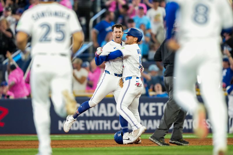 May 17, 2025; Toronto, Ontario, CAN; Toronto Blue Jays third base Ernie Clement (22) celebrates after hitting a walk off single to defeat the Detroit Tigers during the ninth inning in their MLB game at Rogers Centre. Mandatory Credit: Kevin Sousa-Imagn Images