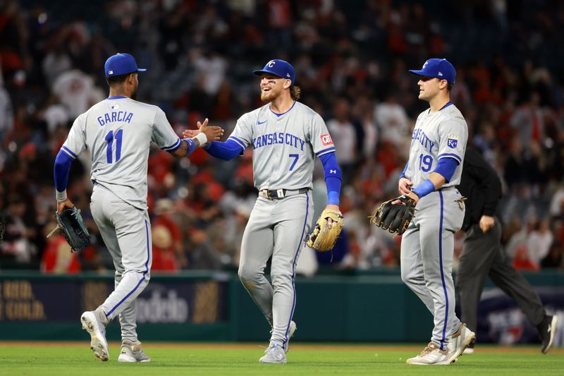 May 10, 2024; Anaheim, California, USA;  Kansas City Royals third base Maikel Garcia (11) and shortstop Bobby Witt Jr. (7) and second base Michael Massey (19) celebrate a victory after defeating the Los Angeles Angels 2-1 at Angel Stadium. Mandatory Credit: Kiyoshi Mio-USA TODAY Sports