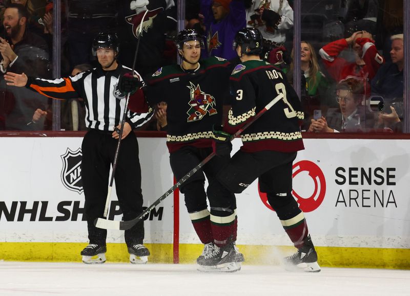 Jan 17, 2023; Tempe, Arizona, USA; Arizona Coyotes right wing Dylan Guenther (11) celebrates a goal with defenseman Josh Brown (3) against the Detroit Red Wings in the third period at Mullett Arena. Mandatory Credit: Mark J. Rebilas-USA TODAY Sports