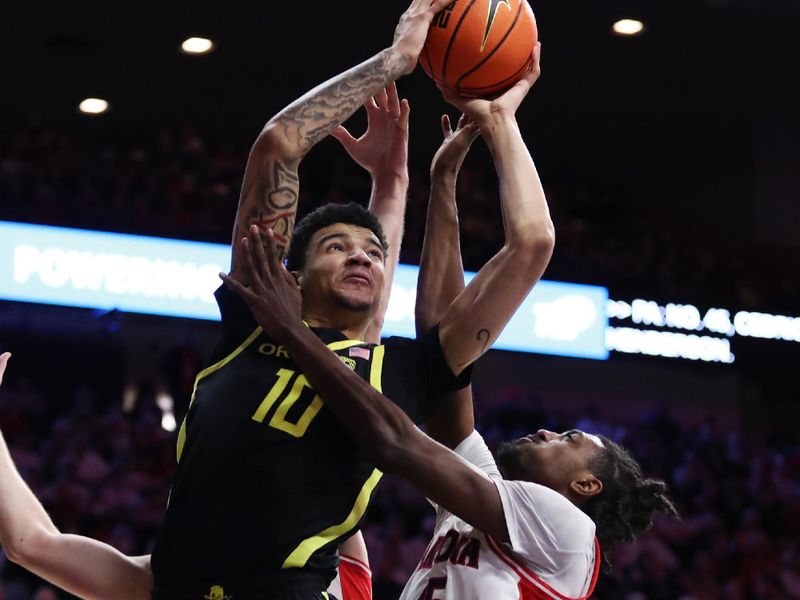 Feb 2, 2023; Tucson, Arizona, USA; Oregon Ducks center Kel'el Ware (10) makes a basket against Arizona Wildcats guard Cedric Henderson Jr. (45) in the first half at McKale Center. Mandatory Credit: Zachary BonDurant-USA TODAY Sports