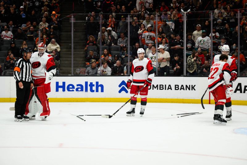 Oct 16, 2025; Anaheim, California, USA; Sticks are seen on the ground after a fight between Anaheim Ducks and Carolina Hurricanes players after the end of the second period at Honda Center. Mandatory Credit: William Liang-Imagn Images