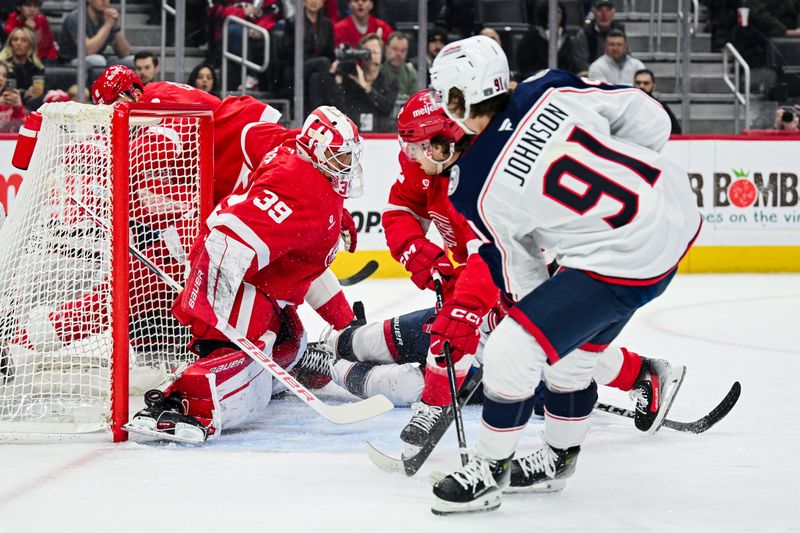 Feb 27, 2025; Detroit, Michigan, USA; Detroit Red Wings goaltender Cam Talbot (39) makes a save against Columbus Blue Jackets center Kent Johnson (91) during the first period at Little Caesars Arena. Mandatory Credit: Tim Fuller-Imagn Images