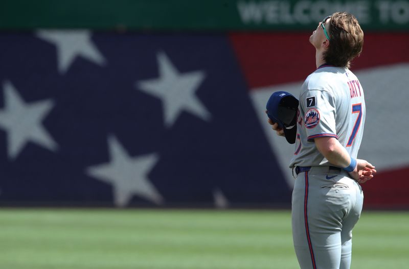 Jun 29, 2025; Pittsburgh, Pennsylvania, USA;  New York Mets third baseman Brett Baty (7) stands for the playing of God Bless America against the Pittsburgh Pirates during the seventh inning stretch at PNC Park. Mandatory Credit: Charles LeClaire-Imagn Images