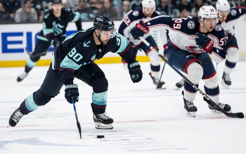 Jan 28, 2024; Seattle, Washington, USA; Seattle Kraken forward Tomas Tatar (90) skates against Columbus Blue Jackets forward Yegor Chinakhov (59) during the second period at Climate Pledge Arena. Mandatory Credit: Stephen Brashear-USA TODAY Sports