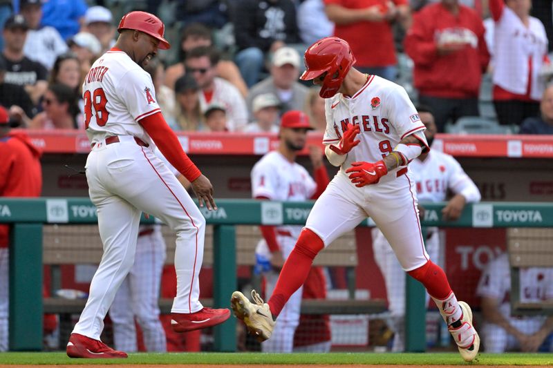 May 26, 2025; Anaheim, California, USA;  Los Angeles Angels shortstop Zach Neto (9) celebrates with third base coach Bo Porter (88) after hitting a solo home run in the first inning against the New York Yankees at Angel Stadium. Mandatory Credit: Jayne Kamin-Oncea-Imagn Images