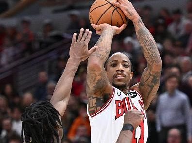 CHICAGO, ILLINOIS - DECEMBER 28:  DeMar DeRozan #11 of the Chicago Bulls attempts a shot over Aaron Nesmith #23 of the Indiana Pacers in the second half on December 28, 2023 at the United Center in Chicago, Illinois. Indiana defeated Chicago 120-104.   NOTE TO USER: User expressly acknowledges and agrees that, by downloading and or using this photograph, User is consenting to the terms and conditions of the Getty Images License Agreement.  (Photo by Jamie Sabau/Getty Images)