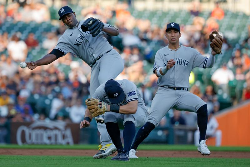 Aug 28, 2023; Detroit, Michigan, USA; New York Yankees starting pitcher Luis Severino (40) makes a throw to first as he avoids shortstop Anthony Volpe (11) and third baseman Gleyber Torres (25) in the second inning at Comerica Park. Mandatory Credit: Rick Osentoski-USA TODAY Sports