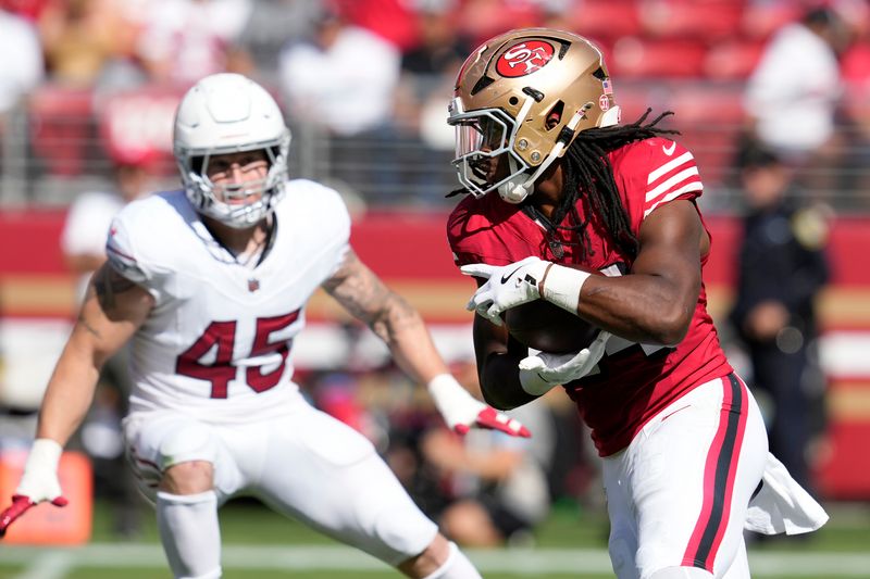 San Francisco 49ers running back Jordan Mason, right, runs against Arizona Cardinals linebacker Dennis Gardeck (45) during the second half of an NFL football game in Santa Clara, Calif., Sunday, Oct. 6, 2024. (AP Photo/Godofredo A. Vásquez)