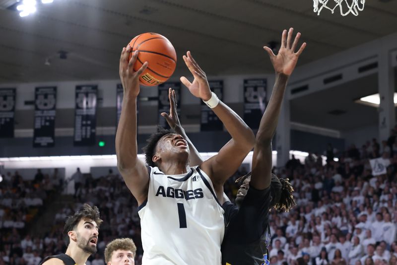 Jan 30, 2024; Logan, Utah, USA; Utah State Aggies forward Great Osobor (1) lays the ball up against San Jose State Spartans center Adrame Diongue (4) during the second half at Dee Glen Smith Spectrum. Mandatory Credit: Rob Gray-USA TODAY Sports