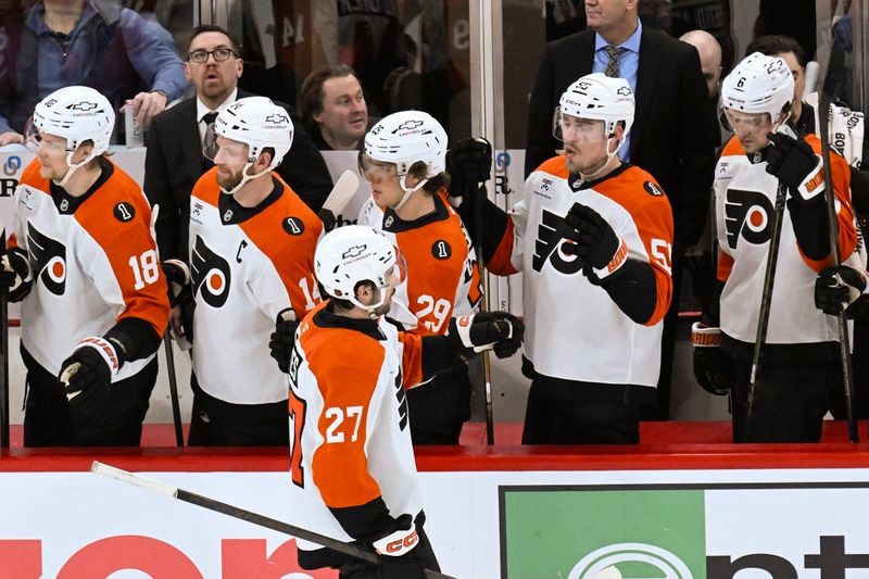Dec 23, 2025; Chicago, Illinois, USA;  Philadelphia Flyers left wing Noah Cates (27) celebrates with teammates after scoring a goal against the Chicago Blackhawks during the second period at United Center. Mandatory Credit: Matt Marton-Imagn Images