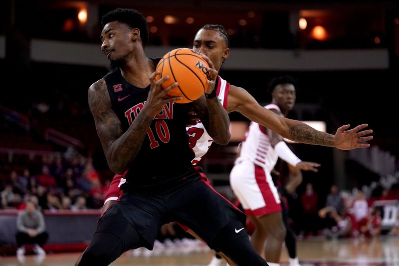 Feb 14, 2024; Fresno, California, USA; UNLV Rebels forward Kalib Boone (10) spins past Fresno State Bulldogs guard Leo Colimerio (23) in the first half at the Save Mart Center. Mandatory Credit: Cary Edmondson-USA TODAY Sports