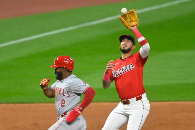 May 3, 2024; Cleveland, Ohio, USA; Cleveland Guardians third baseman Gabriel Arias (13) fields a ball beside Los Angeles Angels second baseman Luis Rengifo (2) in the fifth inning at Progressive Field. Mandatory Credit: David Richard-USA TODAY Sports