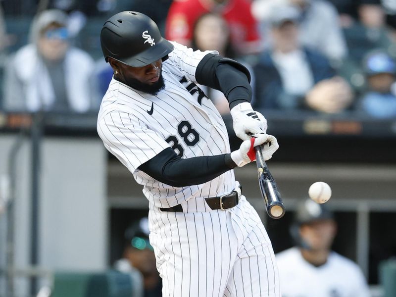 May 24, 2025; Chicago, Illinois, USA; Chicago White Sox center fielder Luis Robert Jr. (88) singles against the Texas Rangers during the sixth inning at Rate Field. Mandatory Credit: Kamil Krzaczynski-Imagn Images