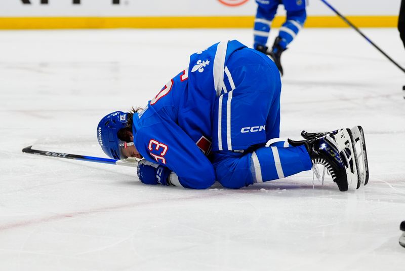 Jan 12, 2026; Denver, Colorado, USA; Colorado Avalanche center Zakhar Bardakov (93) lays on the ice in the third period against the Toronto Maple Leafs  at Ball Arena. Mandatory Credit: Ron Chenoy-Imagn Images
