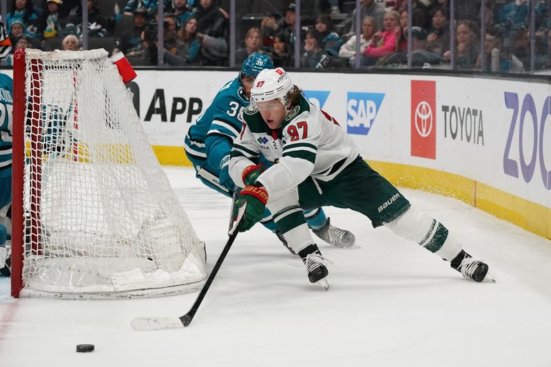 Apr 13, 2024; San Jose, California, USA; Minnesota Wild left wing Kirill Kaprizov (97) skates to goal while being defended by San Jose Sharks defenseman Mario Ferraro (38) during the third period at SAP Center at San Jose. Mandatory Credit: David Gonzales-USA TODAY Sports