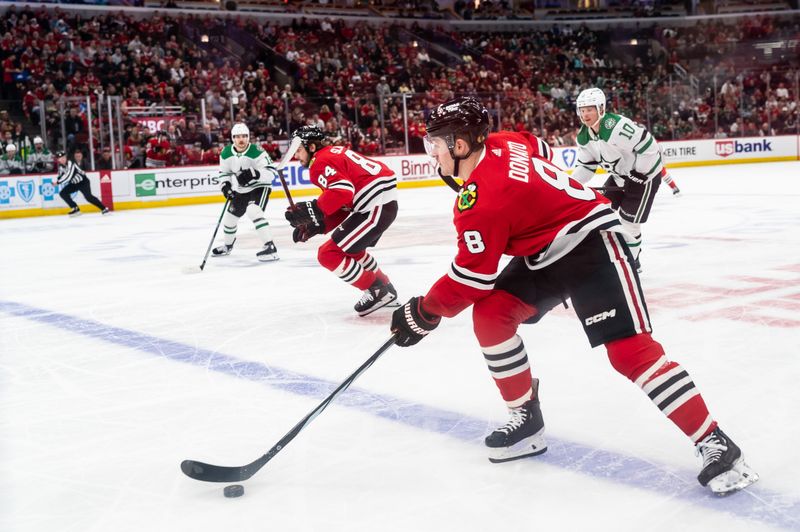 Apr 6, 2024; Chicago, Illinois, USA; Chicago Blackhawks center Ryan Donato (8) moves the puck against the Dallas Stars during the first period at United Center. Mandatory Credit: Seeger Gray-USA TODAY Sports