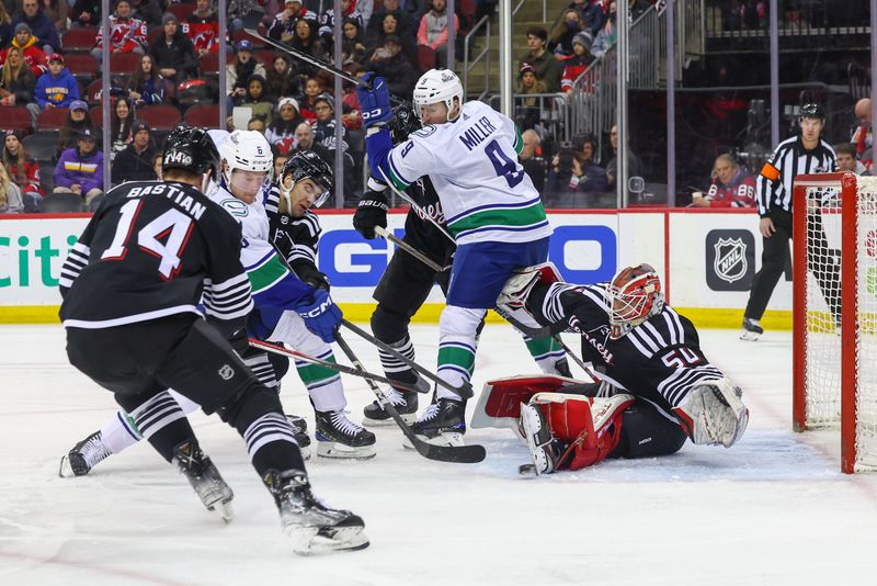 Jan 6, 2024; Newark, New Jersey, USA; New Jersey Devils goaltender Nico Daws (50) makes a save against the Vancouver Canucks during the first period at Prudential Center. Mandatory Credit: Ed Mulholland-USA TODAY Sports