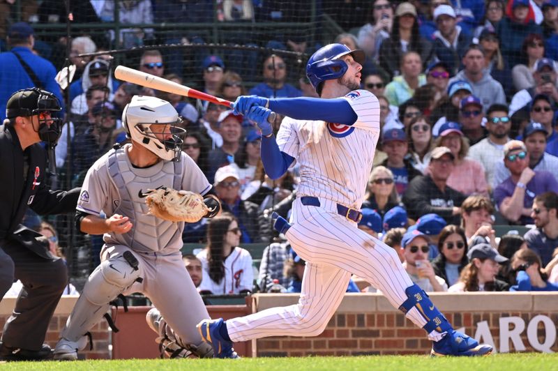 May 26, 2025; Chicago, Illinois, USA; Chicago Cubs right fielder Kyle Tucker (30) hits an RBI sacrifice fly ball during the seventh inning against the Colorado Rockies at Wrigley Field. Mandatory Credit: Patrick Gorski-Imagn Images