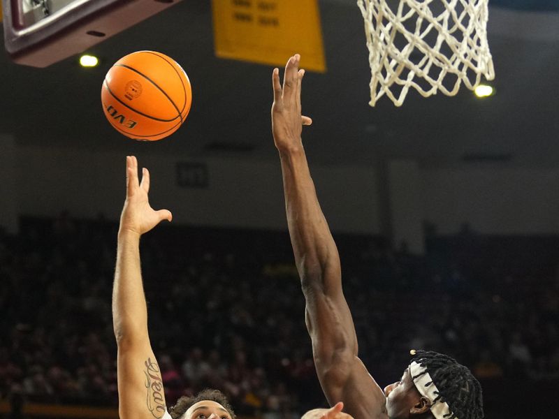 Feb 24, 2024; Tempe, Arizona, USA; Arizona State Sun Devils guard Jose Perez (12) shoots over Washington State Cougars center Rueben Chinyelu (20) during the second half at Desert Financial Arena. Mandatory Credit: Joe Camporeale-USA TODAY Sports