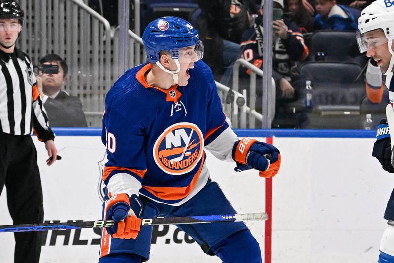 Mar 23, 2024; Elmont, New York, USA;  New York Islanders right wing Hudson Fasching (20) celebrates his goal against the Winnipeg Jets during the second period at UBS Arena. Mandatory Credit: Dennis Schneidler-USA TODAY Sports