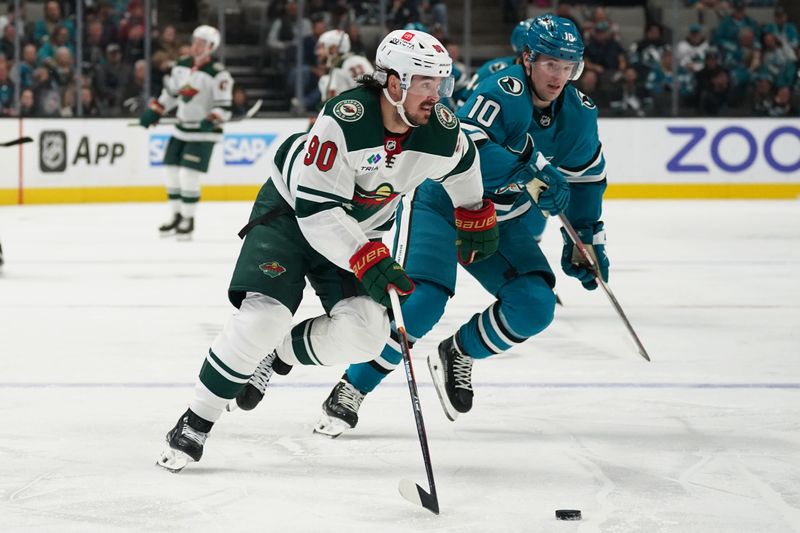 Apr 13, 2024; San Jose, California, USA; Minnesota Wild center Marcus Johansson (90) controls the puck against San Jose Sharks center Klim Kostin (10) during the first period at SAP Center at San Jose. Mandatory Credit: David Gonzales-USA TODAY Sports