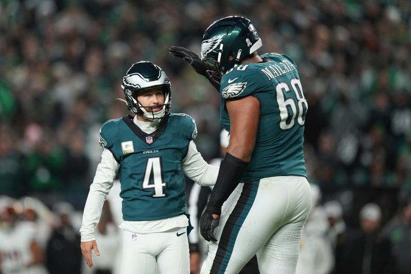 Philadelphia Eagles place kicker Jake Elliott (4) is congratulated by teammate Jordan Mailata (68) after making a 21-yard field goal during the first half of an NFL football game against the Washington Commanders Thursday, Nov. 14, 2024, in Philadelphia. (AP Photo/Matt Slocum)