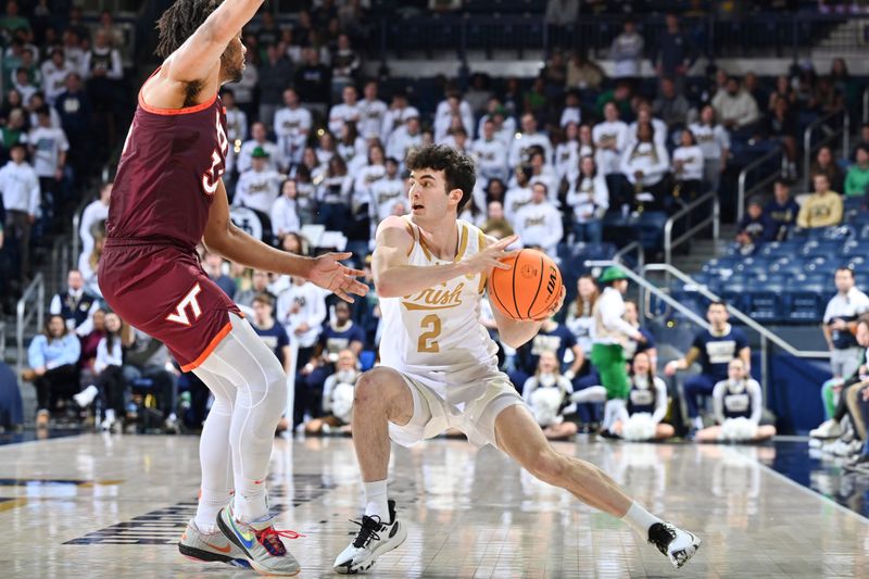 Feb 10, 2024; South Bend, Indiana, USA; Notre Dame Fighting Irish guard Logan Imes (2) looks to pass as Virginia Tech Hokies forward Mylyjael Poteat (34) defends in the second half at the Purcell Pavilion. Mandatory Credit: Matt Cashore-USA TODAY Sports