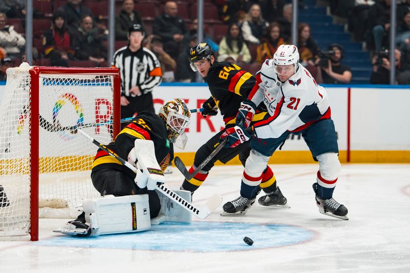 Jan 21, 2026; Vancouver, British Columbia, CAN; Vancouver Canucks goalie Kevin Lankinen (32) makes a save on Washington Capitals forward Aliaksei Protas (21) in the first period at Rogers Arena. Mandatory Credit: Bob Frid-Imagn Images