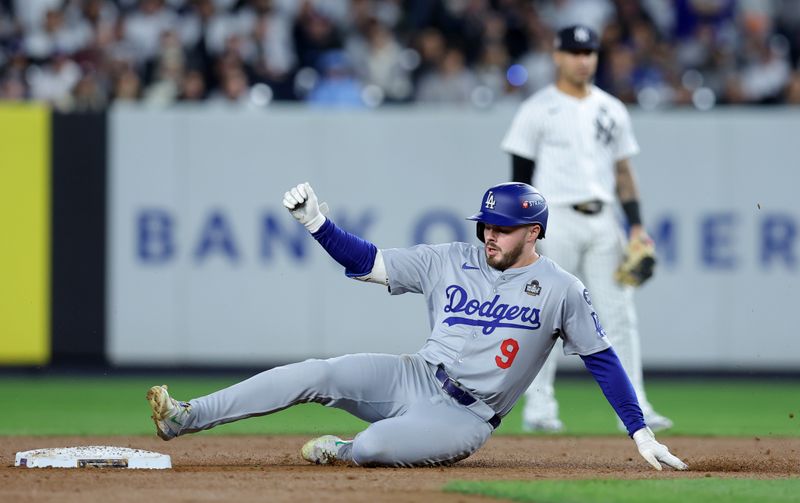 Oct 29, 2024; New York, New York, USA; Los Angeles Dodgers second baseman Gavin Lux (9) slides into second with a double during the second inning in game four of the 2024 MLB World Series against the New York Yankees at Yankee Stadium. Mandatory Credit: Brad Penner-Imagn Images