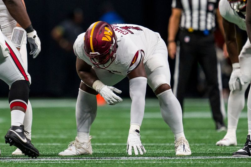 Washington Commanders offensive tackle Saahdiq Charles (77) lines up during the first half of an NFL football game against the Atlanta Falcons, Sunday, Oct. 15, 2023, in Atlanta. The Washington Commanders won 24-16. (AP Photo/Danny Karnik)