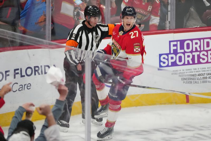 Oct 19, 2024; Sunrise, Florida, USA;  Florida Panthers center Eetu Luostarinen (27) celebrates after a goal against the Vegas Golden Knights during the third period at Amerant Bank Arena. Mandatory Credit: Jim Rassol-Imagn Images