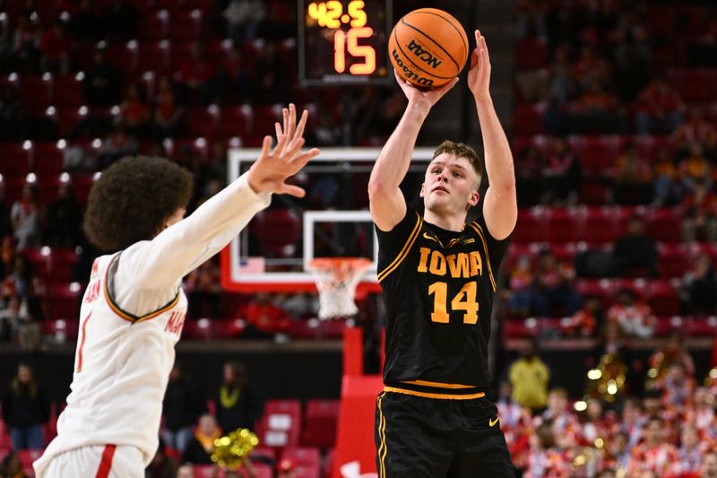 Feb 11, 2026; College Park, Maryland, USA;  Iowa Hawkeyes guard Bennett Stirtz (#14) shoots for three points in the first half against the Maryland Terrapins at Xfinity Center. Mandatory Credit: Jamie Sabau-Imagn Images