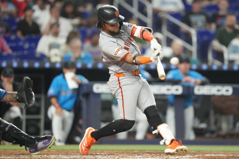 Jun 1, 2025; Miami, Florida, USA;  San Francisco Giants center fielder Luis Matos (29) hits a three-run home run in the fourth inning against the Miami Marlins at loanDepot Park. Mandatory Credit: Jim Rassol-Imagn Images