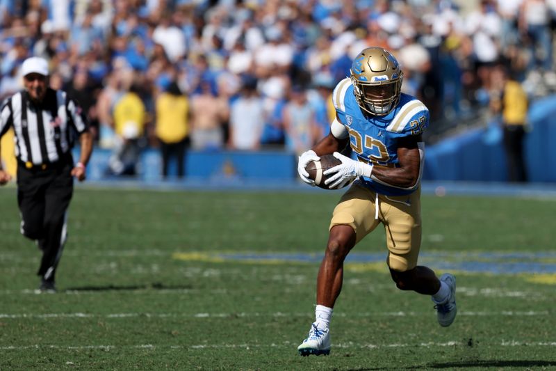 Oct 8, 2022; Pasadena, California, USA;  UCLA Bruins running back Keegan Jones (22) runs with a ball during the third quarter against the Utah Utes at Rose Bowl. Mandatory Credit: Kiyoshi Mio-USA TODAY Sports