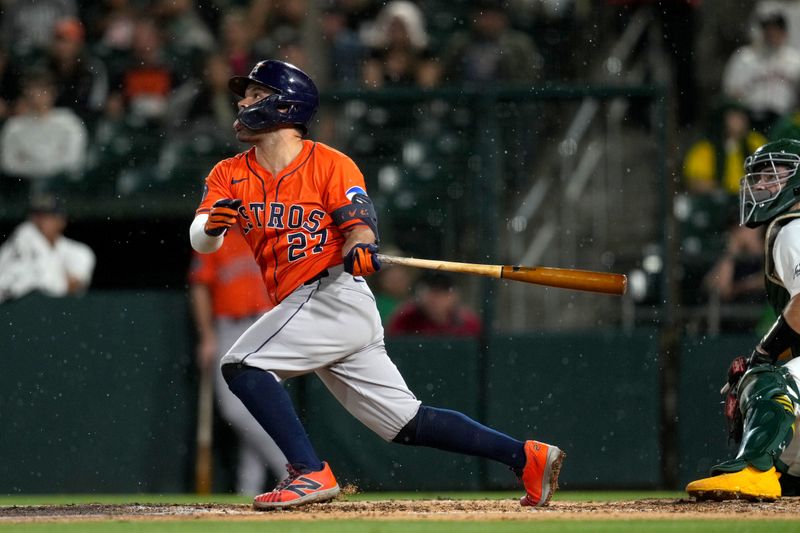 Sep 24, 2025; West Sacramento, California, USA; Houston Astros second baseman Jose Altuve (27) hits a fly ball against the Athletics in the sixth inning at Sutter Health Park. Mandatory Credit: Cary Edmondson-Imagn Images