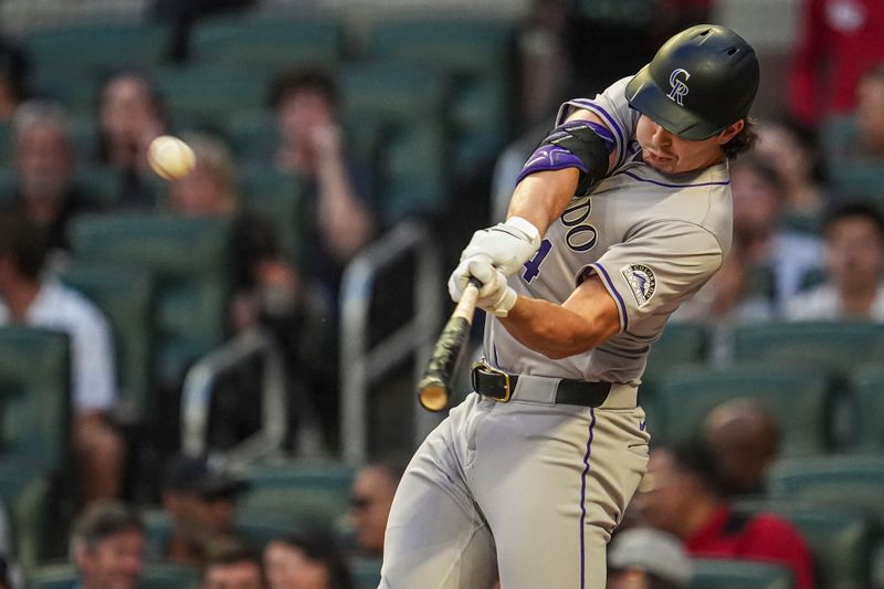 Sep 5, 2024; Cumberland, Georgia, USA; Colorado Rockies center fielder Brenton Doyle (9) hits a home run against the Atlanta Braves during the second inning at Truist Park. Mandatory Credit: Dale Zanine-Imagn Images