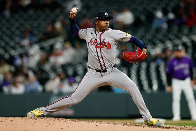 Apr 28, 2025; Denver, Colorado, USA; Atlanta Braves relief pitcher Raisel Iglesias (26) pitches in the ninth inning against the Colorado Rockies at Coors Field. Mandatory Credit: Isaiah J. Downing-Imagn Images