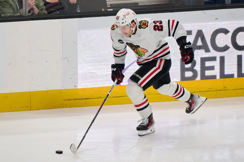 Mar 23, 2024; San Jose, California, USA; Chicago Blackhawks center Philipp Kurashev (23) plays the puck against the San Jose Sharks during the third period at SAP Center at San Jose. Mandatory Credit: Robert Edwards-USA TODAY Sports