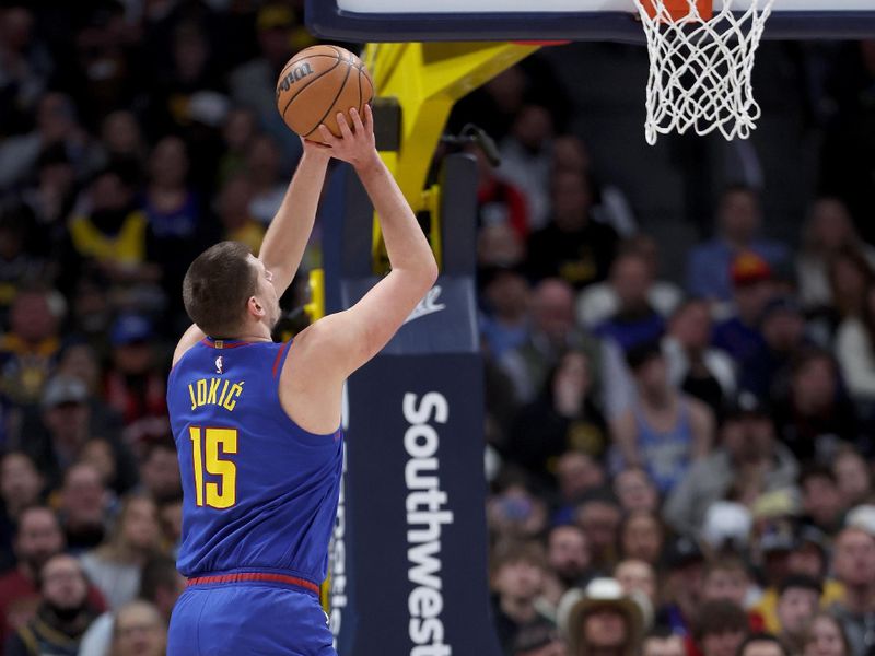 DENVER, COLORADO - JANUARY 05: Nikola Jokic #15 of the Denver Nuggets goes to the basket against Moritz Wagner #21 of the Orlando Magic in the first quarter at Ball Arena on January 05, 2024 in Denver, Colorado.  NOTE TO USER: User expressly acknowledges and agrees that, by downloading and or using this photograph, User is consenting to the terms and conditions of the Getty Images License Agreement.  (Photo by Matthew Stockman/Getty Images)