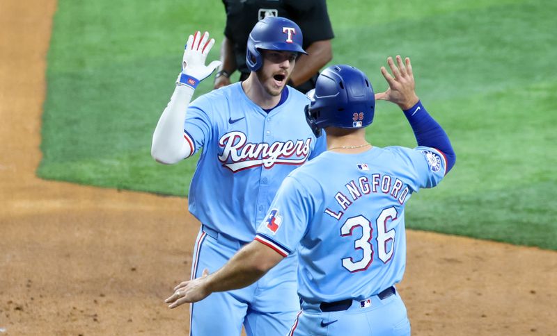 Jul 21, 2024; Arlington, Texas, USA; Texas Rangers catcher Jonah Heim (28) celebrates with Texas Rangers left fielder Wyatt Langford (36) after hitting a three run home run during the fourth inning against the Baltimore Orioles at Globe Life Field. Mandatory Credit: Kevin Jairaj-USA TODAY Sports