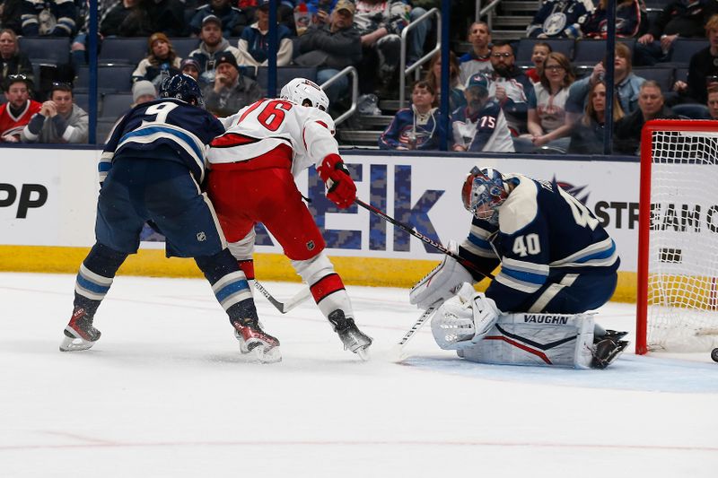 Feb 29, 2024; Columbus, Ohio, USA; Carolina Hurricanes defenseman Brady Skjei (76) slides the puck through the pads of Columbus Blue Jackets goalie Daniil Tarasov (40) for a gaol during the second period at Nationwide Arena. Mandatory Credit: Russell LaBounty-USA TODAY Sports