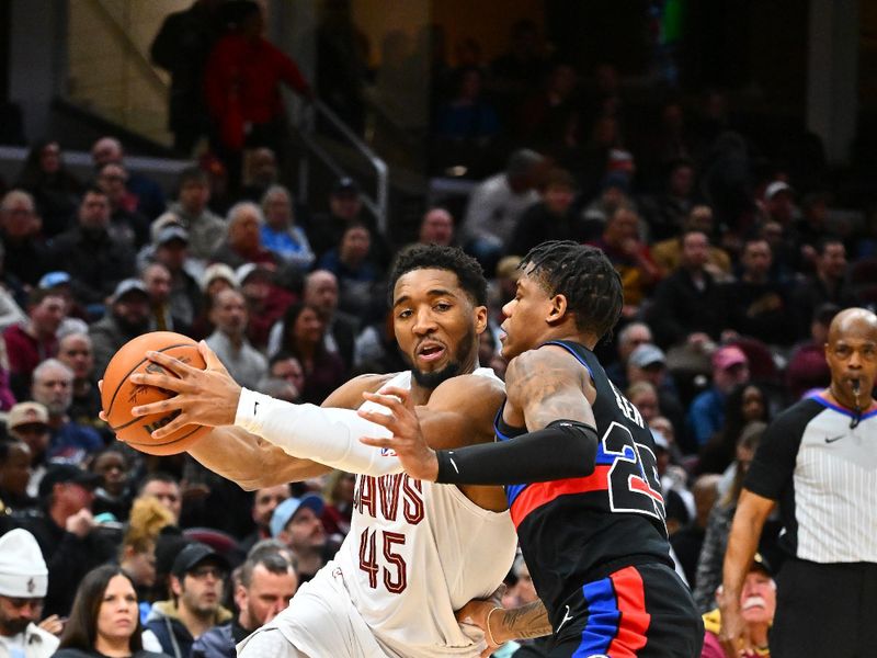 CLEVELAND, OHIO - JANUARY 27: Donovan Mitchell #45 of the Cleveland Cavaliers drives to the basket around Marcus Sasser #25 of the Detroit Pistons during the third quarter at Rocket Mortgage Fieldhouse on January 27, 2025 in Cleveland, Ohio. The Cavaliers defeated the Pistons 110-91. NOTE TO USER: User expressly acknowledges and agrees that, by downloading and or using this photograph, User is consenting to the terms and conditions of the Getty Images License Agreement. (Photo by Jason Miller/Getty Images)