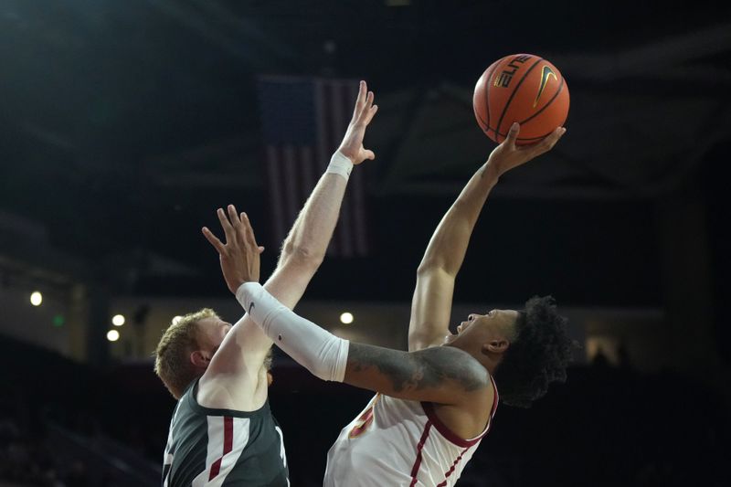 Jan 10, 2024; Los Angeles, California, USA; Southern California Trojans guard Boogie Ellis (5) shoots the ball against Washington State Cougars guard Jabe Mullins (3) in the second half at Galen Center. Mandatory Credit: Kirby Lee-USA TODAY Sports