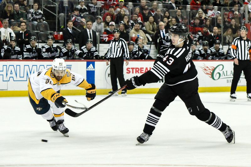 Apr 7, 2024; Newark, New Jersey, USA; New Jersey Devils defenseman Luke Hughes (43) shoots the puck while being defended by Nashville Predators center Tommy Novak (82) during overtime at Prudential Center. Mandatory Credit: John Jones-USA TODAY Sports