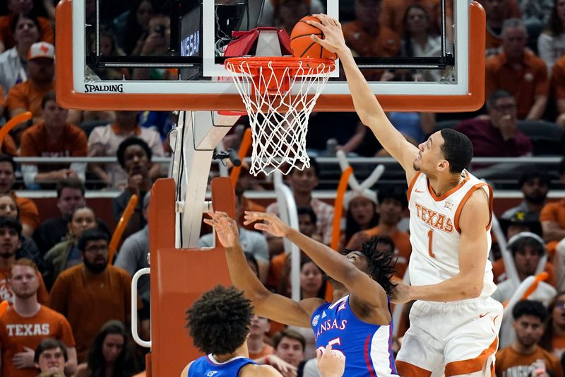 Mar 4, 2023; Austin, Texas, USA; Texas Longhorns forward Dylan Disu (1) attempts to dunk over Kansas Jayhawks forward Zuby Ejiofor (35) during the second half at Moody Center. Mandatory Credit: Scott Wachter-USA TODAY Sports