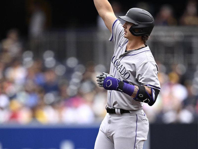 May 15, 2024; San Diego, California, USA; Colorado Rockies left fielder Jordan Beck (27) celebrates after hitting a two-RBI double against the San Diego Padres during the second inning at Petco Park. Mandatory Credit: Orlando Ramirez-USA TODAY Sports